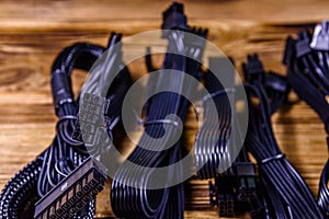 Set of computer psu cables on a wooden background