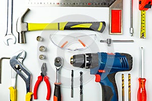 Set of construction tools on white background as wrench, hammer, pliers, socket wrench, spanner, tape measure, electric