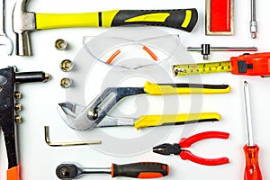 Set of construction tools on white background as wrench, hammer, pliers, socket wrench, spanner, tape measure, electric