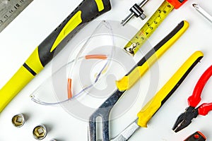 Set of construction tools on white background as wrench, hammer, pliers, socket wrench, spanner, tape measure, electric