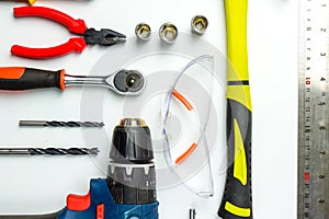 Set of construction tools on white background as wrench, hammer, pliers, socket wrench, spanner, tape measure, electric