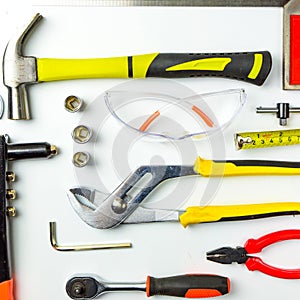 Set of construction tools on white background as wrench, hammer, pliers, socket wrench, spanner, tape measure, electric