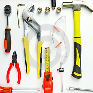 Set of construction tools on white background as wrench, hammer, pliers, socket wrench, spanner, tape measure, electric