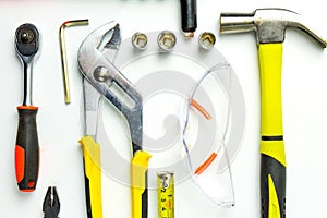 Set of construction tools on white background as wrench, hammer, pliers, socket wrench, spanner, tape measure, electric