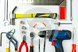 Set of construction tools on white background as wrench, hammer, pliers, socket wrench, spanner, tape measure, electric