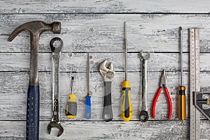 Set of construction tools on the white,rustic wooden background