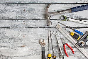 Set of construction tools on the white,rustic wooden background