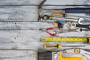 Set of construction tools on the white,rustic wooden background