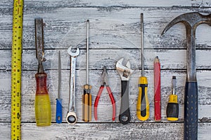 Set of construction tools on the white,rustic wooden background