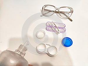 A set for contact lenses with a container, forceps, glasses. The concept of correcting myopia. Contact lens care