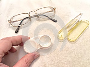 A set for contact lenses with a container, forceps, glasses. The concept of correcting myopia. Contact lens care