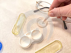 A set for contact lenses with a container, forceps, glasses. The concept of correcting myopia. Contact lens care