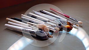 Set cosmetic brushe. Professional visage brushes for face makeup on table.