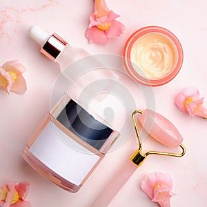 Set of cosmetic products for face skin care. Flat lay composition with moisturizer lotion, face cream, face massage roller. Facial