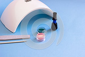 Set of cosmetic tools for manicure and pedicure on a blue background.