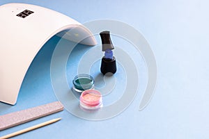 Set of cosmetic tools for manicure and pedicure on a blue background.