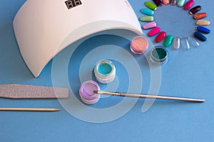 Set of cosmetic tools for manicure and pedicure on a blue background.