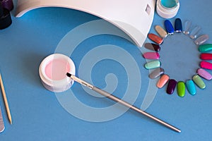 Set of cosmetic tools for manicure and pedicure on a blue background.