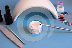 Set of cosmetic tools for manicure and pedicure on a blue background.