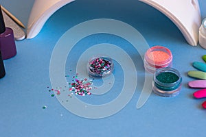 Set of cosmetic tools for manicure and pedicure on a blue background.