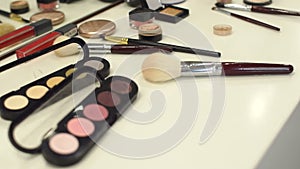 Set of cosmetics for make-up on a white table.