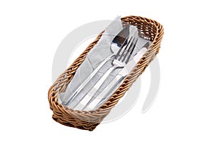 Set of cutlery in basket isolated on white