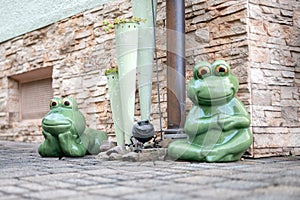 Set of decoration ceramic frogs in various funny poses for home and garden