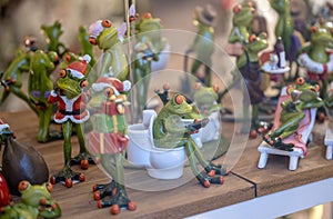 Set of decoration ceramic frogs in various funny poses for home and garden