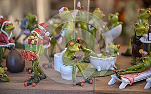Set of decoration ceramic frogs in various funny poses for home and garden