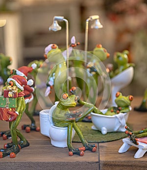 Set of decoration ceramic frogs in various funny poses for home and garden