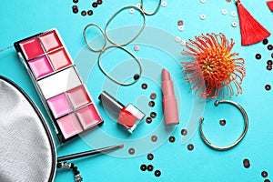 Set of decorative cosmetics and accessories on color background