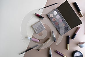 Set of decorative cosmetics on a beige background.
