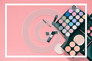 Set of decorative cosmetics on light colorful pink background.