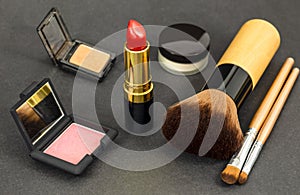 Set of decorative cosmetics, professional makeup tools brushes on black background