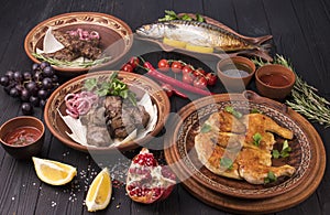 Set with delicious food on ethnic plates