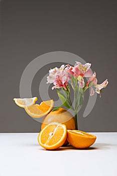 Set of delicious, juicy sliced oranges and lemon isolated over brown background. Flower element