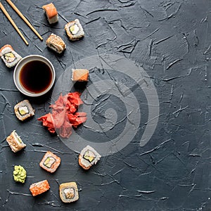 Set of delicious sushi with ginger and wasabi on a gray background, space for text
