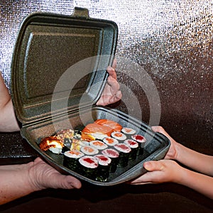 Set of delicious sushi rolls with wassabi and ginger in a box. Japanese food. photo