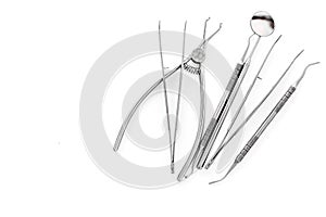 Set of dentists tools including round mirror on white background top view copyspace