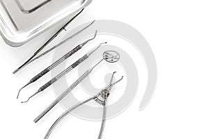 Set of dentists tools near cuvette on white background top view copyspace