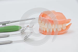 Set of dentures and dental tools.