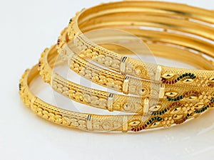 Set of designed gold bangles photo