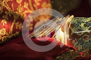 Set of diamond bangles on a red backdrop