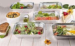 Set of diet dishes in containers on a light wooden background. Takeaway. Diet and healthy food