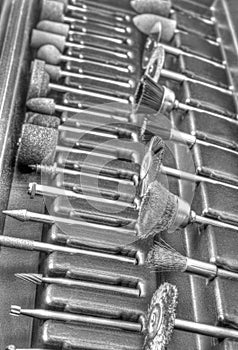 Set of different accessories for mini drill machine in black and white