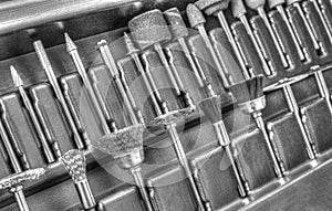 Set of different accessories for mini drill machine in black and white