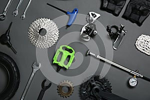 Set of different bicycle tools and parts on background, flat lay