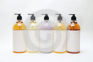 Set of different bottles for beauty, hygiene and health on a white background with reflection