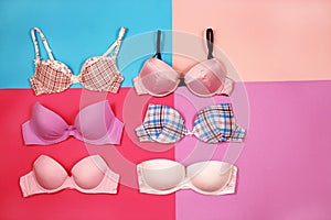 Set of different bras on multicolored background