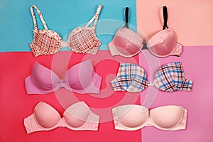 Set of different bras on multicolored background